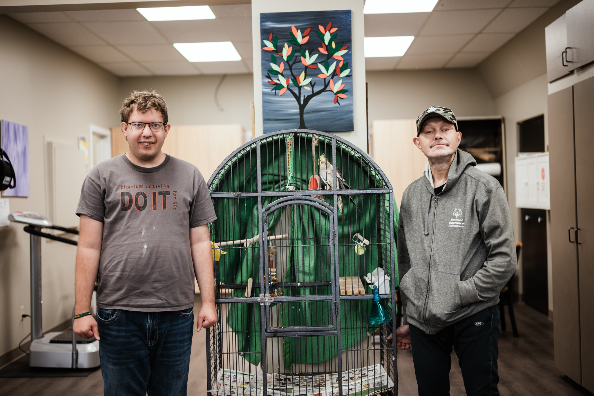 Two persons standing near cage Two persons standing near cage